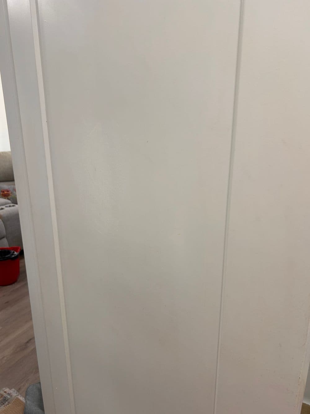 White door with simplistic design and silver doorknob, interior setting.